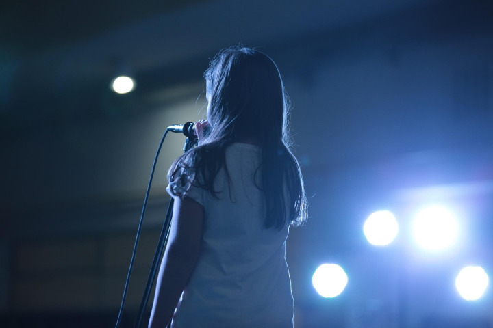 author reading with microphone